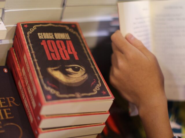A boy reads a book next to copies of British writer George Orwell's 1984 at Hong Kong's an