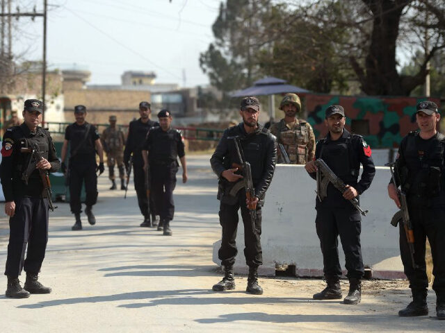 Pakistani soldiers and policemen stand guard outside central jail where an anti-terrorist