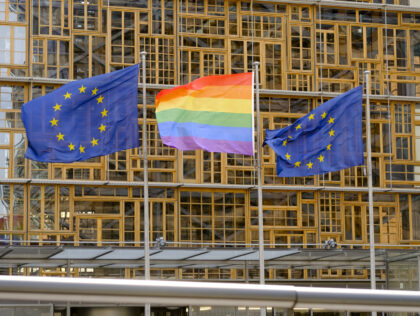 BRUSSELS, BELGIUM - MAY 17, 2018: The Rainbow flag (LGBT movement) and the EU flags are seen in front of the Europa, the EU Council headquarter in Brussels, Belgium, 17 May 2018. (Photo by Thierry Monasse/Getty Images)