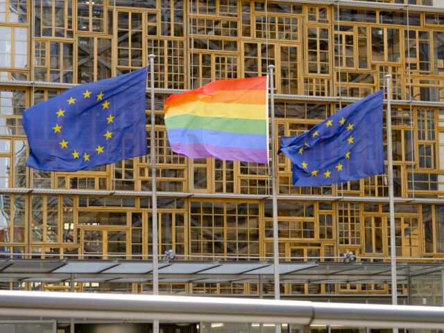 BRUSSELS, BELGIUM - MAY 17, 2018: The Rainbow flag (LGBT movement) and the EU flags are se