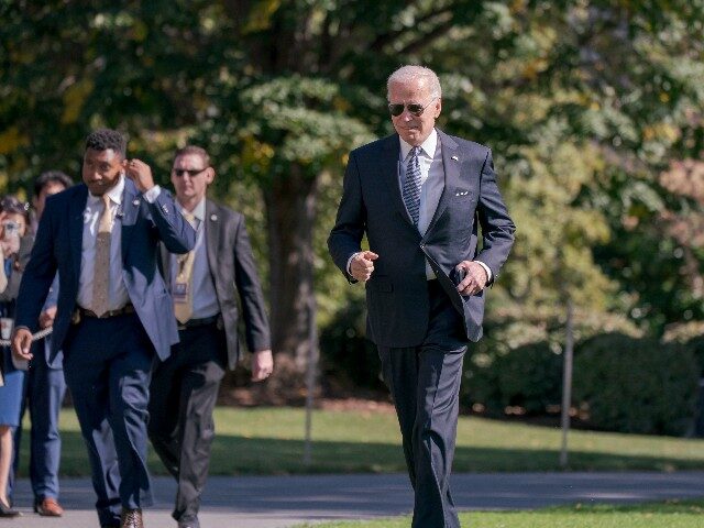 President Joe Biden jogs across the South Lawn at the White House in Washington to talk to