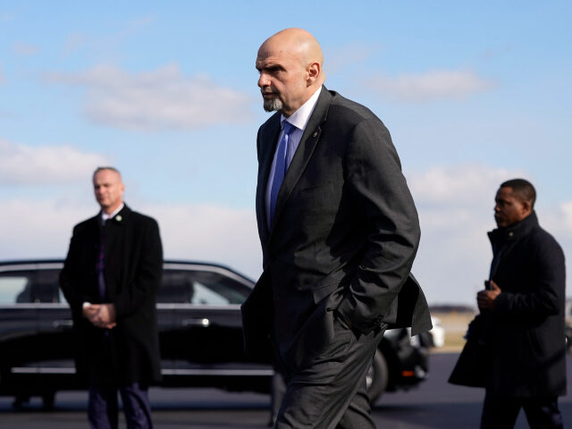 FILE - Sen. John Fetterman, D-Pa., walks to a motorcade vehicle after stepping off Air Force One behind President Joe Biden, Feb. 3, 2023, at Philadelphia International Airport in Philadelphia. On Thursday, Feb. 16, Fetterman's office announced that the senator had checked himself into the hospital for clinical depression.(AP Photo/Patrick …
