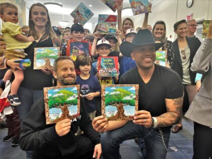 Kirk Cameron and Coffey Anderson hold copies of Cameron's book 'As You Grow' amid crowds gathered for story time. (Amplifi Agency)