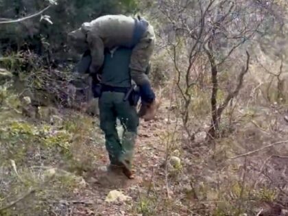 A Three Points Station agents carries an injured migrant down a mountain near the Arizona-Mexico border. (U.S. Border Patrol/Tucson Sector)