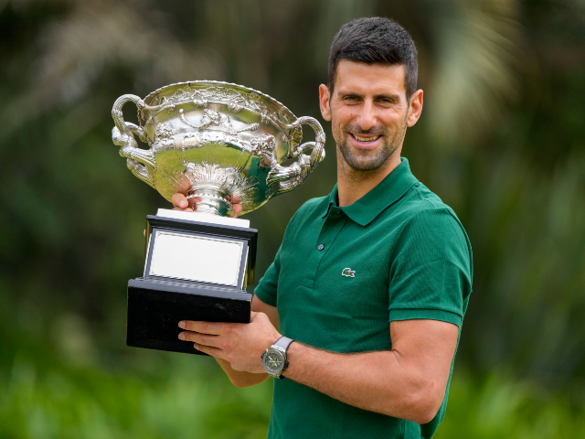 Novak Djokovic of Serbia poses with the Norman Brookes Challenge Cup in the gardens of Government House the morning after defeating Stefanos Tsitsipas of Greece in the men's singles final at the Australian Open tennis championship in Melbourne, Australia, Monday, Jan. 30, 2023. (AP Photo/Mark Baker)