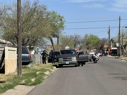Police interview victim near scene of Monday's shooting.