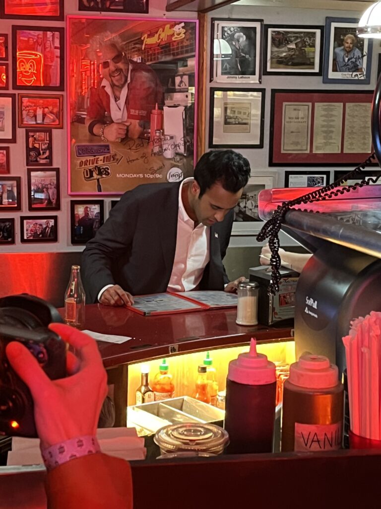 Vivek Ramaswamy looks over the menu at Red Arrow Diner in Manchester, a renowned campaign stop for candidates (Nick Gilbertson/Breitbart News).