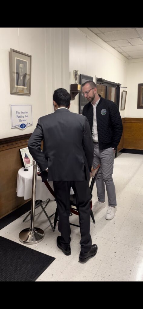Vivek Ramaswamy takes in the Missing Man Table at Rochester City Hall (Nick Gilbertson/Breitbart News).