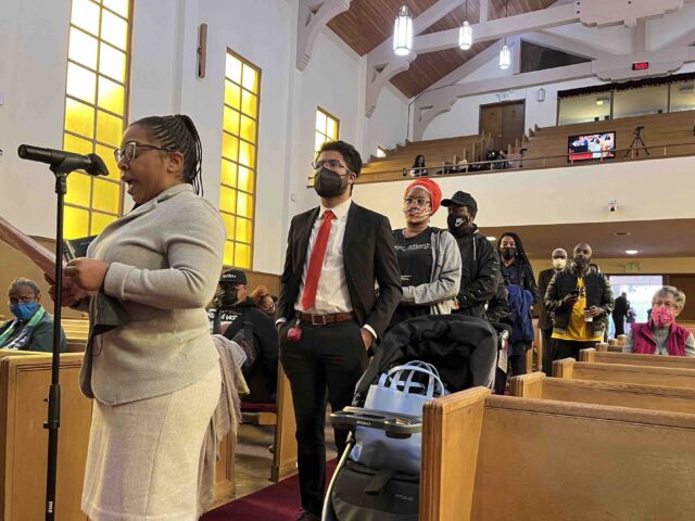 FILE - People line up to speak during a reparations task force meeting at Third Baptist Ch