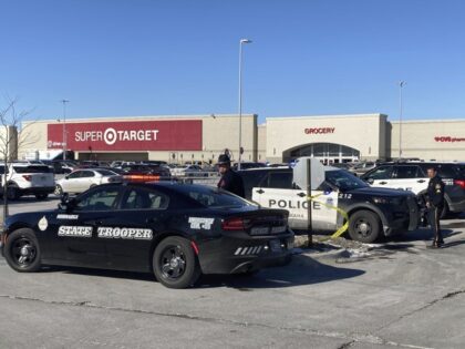 Police officers investigate after they say a man armed with an assault-style rifle and ammunition went into a Target store in Omaha, Neb., and began firing on Tuesday, Jan. 31, 2023, before he was shot dead by police. (AP Photo/Josh Funk)