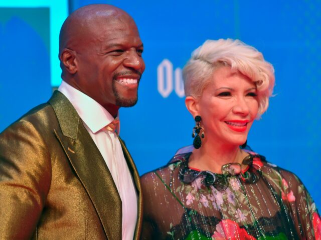 US actor Terry Crews and his wife Rebecca King-Crews pose on the red carpet ahead of the M