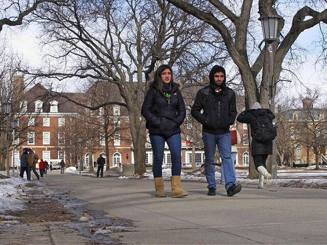 FILE - In this Jan. 27, 2014, file photo, students walk between buildings on the University of Illinois campus in Urbana, Ill. The U of I has partied its way into the top spot on an annual list of top party schools in the country. The Urbana-Champaign campus has been …