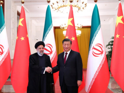 In this photo released by the official website of the office of the Iranian Presidency, President Ebrahim Raisi, left, shakes hands with his Chinese counterpart Xi Jinping in an official welcoming ceremony in Beijing, Tuesday, Feb. 14, 2023. (Iranian Presidency Office via AP)