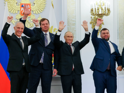From left, Moscow-appointed head of Kherson Region Vladimir Saldo, Moscow-appointed head of Zaporizhzhia region Yevgeny Balitsky, Russian President Vladimir Putin, center, Denis Pushilin, the leader of the Donetsk People's Republic and Leonid Pasechnik, leader of self-proclaimed Luhansk People's Republic wave during a ceremony to sign the treaties for four regions …