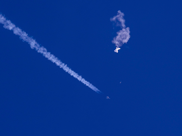 In this photo provided by Chad Fish, the remnants of a large balloon drift above the Atlantic Ocean, just off the coast of South Carolina, with a fighter jet and its contrail seen below it, Saturday, Feb. 4, 2023. The downing of the suspected Chinese spy balloon by a missile …