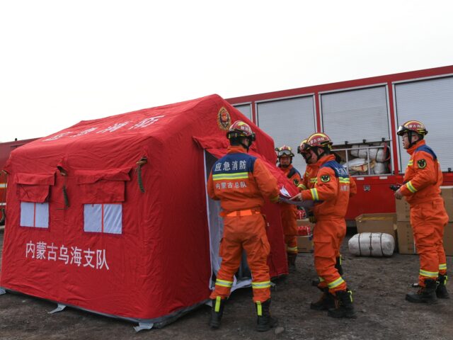 Rescue workers gather at the site of a collapsed coal mine in Alxa League, north China's I