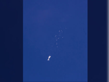 FILE - The remnants of a large balloon descend after it was struck by a missile from an F-22 fighter jet over the Atlantic Ocean, just off the coast of South Carolina near Myrtle Beach, Feb. 4, 2023. China's ceremonial parliament has accused American lawmakers of trampling on the sovereignty …
