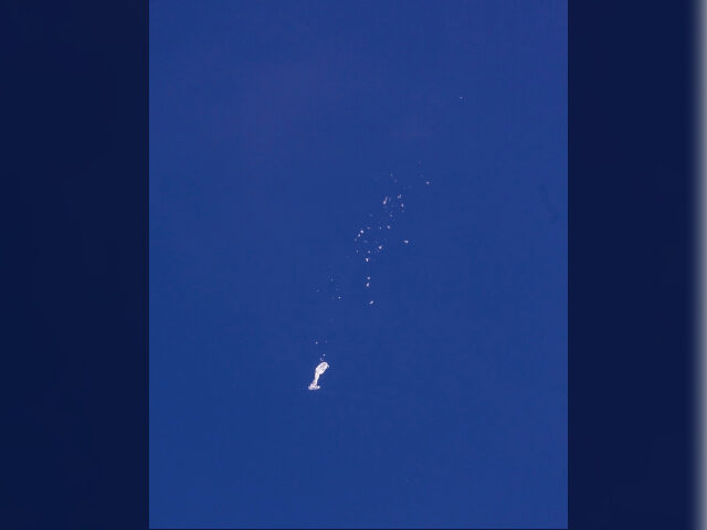 FILE - The remnants of a large balloon descend after it was struck by a missile from an F-