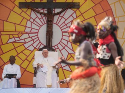 Pope Francis looks at traditional dancers performing at the Martyrs' Stadium In Kinshasa, Democratic Republic of Congo, Thursday, Feb. 2, 2023. Francis is in Congo and South Sudan for a six-day trip, hoping to bring comfort and encouragement to two countries that have been riven by poverty, conflicts and what …