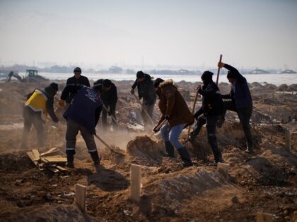 Municipal grave diggers bury the bodies of four people, three of the them not claimed relatives, in a makeshift cemetery on the outskirts of Elbistan, Turkey, Saturday, Feb. 11, 2023. Rescue crews on Saturday pulled more survivors, including entire families, from toppled buildings despite diminishing hopes as the death toll …