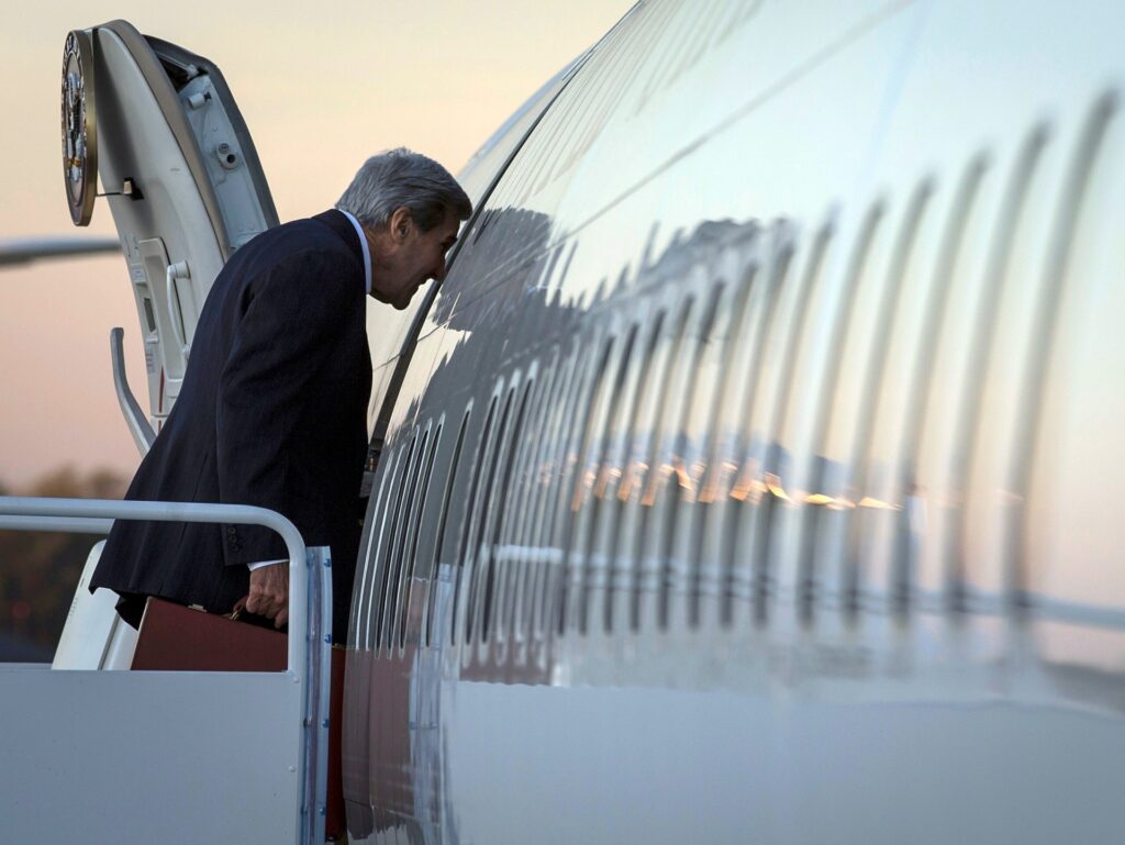 U.S. Secretary of State John Kerry boards his plane to Germany at Joint Base Andrews, Md., Wednesday, Oct 21, 2015. The Obama administration is confronted with two crises for which it has few, if any, viable options, the Israeli-Palestinian conflict and the Syrian civil war. The administration has ultimate goals for each crisis but no clear path to achieve them and Kerry is jetting off to Europe and the Middle East to seek answers. (Carlo Allegri/Pool Photo via AP)