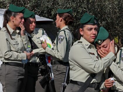 Israeli police mourn during the funeral of their fellow Asil Suaed, who was killed in a stabbing attack carried out by a Palestinian boy in annexed east Jerusalem, in the Bedouin town of Hussniyya in northern Israel on February 14, 2023. (Photo by JACK GUEZ / AFP) (Photo by JACK …