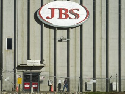 FILE - A worker heads into the JBS meatpacking plant in Greeley, Colo., on Oct. 12, 2020.