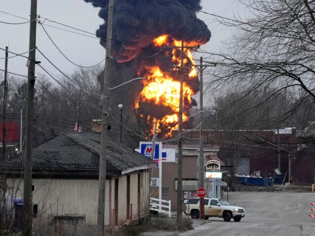 A black plume and fireball rise over East Palestine, Ohio, as a result of a controlled det