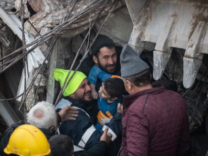 HATAY, TURKEY - FEBRUARY 08: Rescue workers carry Yigit Cakmak, 8-years-old survivor at th