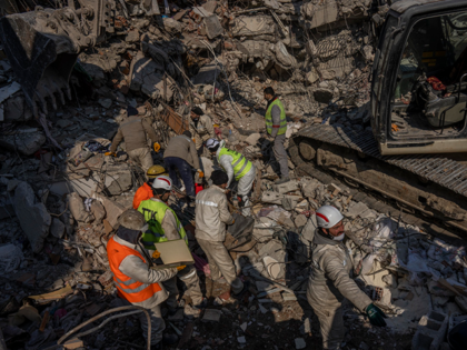 Members of a search and rescue team work on a collapsed structure after the earthquake in