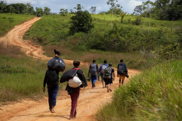 Alleged illegal miners leave a mining area inside Yanomami Indigenous land in northwestern