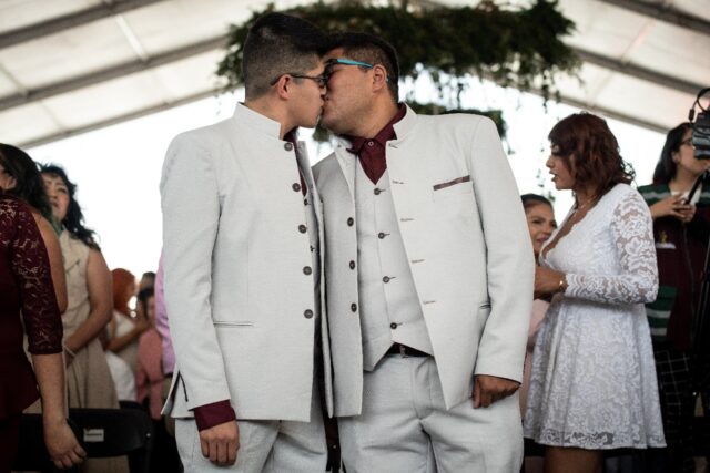 A couple kiss during a mass wedding celebration in Mexico on Valentine's Day