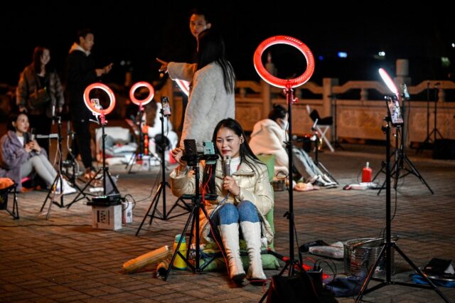 Livestreamers gather on a bridge in the Chinese city of Guilin in the hopes of catching th