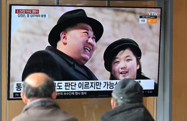 North Korean leader Kim Jong Un (L) and his daughter Ju Ae are seen on a television in Seo