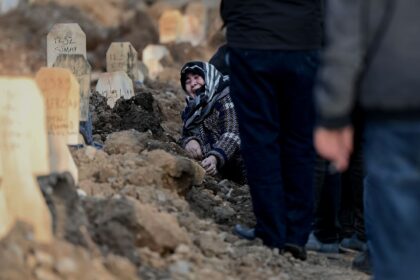 Some of the wooden headstones at a grave in Kahramanmaras carry the name of the quake vict