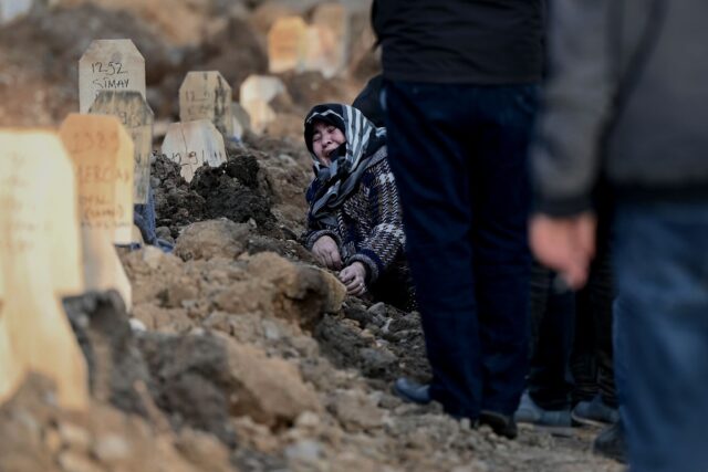Some of the wooden headstones at a grave in Kahramanmaras carry the name of the quake vict
