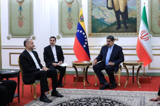 Venezuelan President Nicolas Maduro (R) meets with Iranian Foreign Minister Hossein Amir-A
