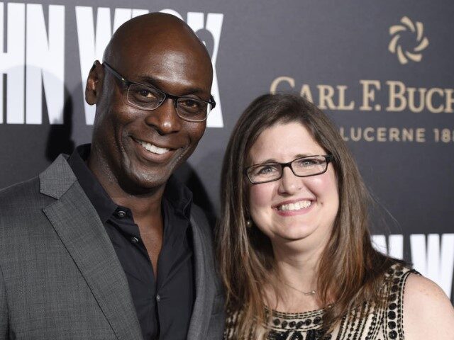 Lance Reddick, a cast member in "John Wick: Chapter 2," poses with his wife Stephanie at t