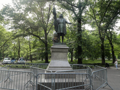 New York Police officers are stationed near a statue of Christopher Columbus in Central Park Thursday, June 18, 2020, in New York. (AP Photo/Frank Franklin II)