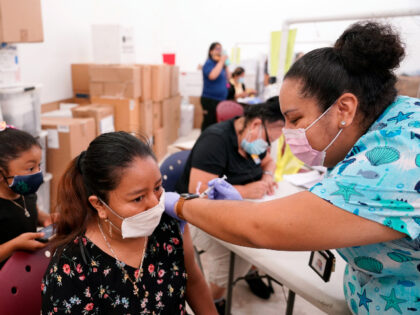 Registered nurse Ashleigh Velasco, right, administers the Johnson & Johnson COVID-19 vaccine to Olga Perez at a clinic held by Healthcare Network, Saturday, April 10, 2021, in Immokalee, Fla. The clinic is focusing on inoculating migrant farmworkers and their families. Healthcare Network is working with the Coalition of Immokalee Workers …