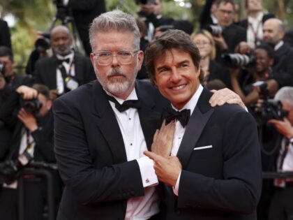 Screenwriter Christopher McQuarrie, left, and Tom Cruise pose for photographers upon arrival at the premiere of the film 'Top Gun: Maverick' at the 75th international film festival, Cannes, southern France, Wednesday, May 18, 2022. (Photo by Vianney Le Caer/Invision/AP)