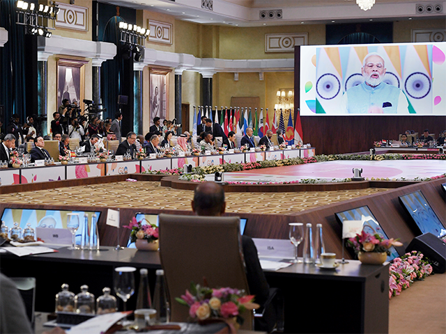 India's Prime Minister Narendra Modi, seen on screen, addresses the G20 foreign ministers'