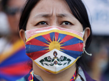 A Tibetan woman wears a face mask featuring the Tibetan national flag during a march in Taipei, Taiwan, Sunday, March 5, 2023, marking the 64th anniversary of the failed 1959 Tibetan uprising against Chinese rule. (AP Photo/Chiang Ying-ying)