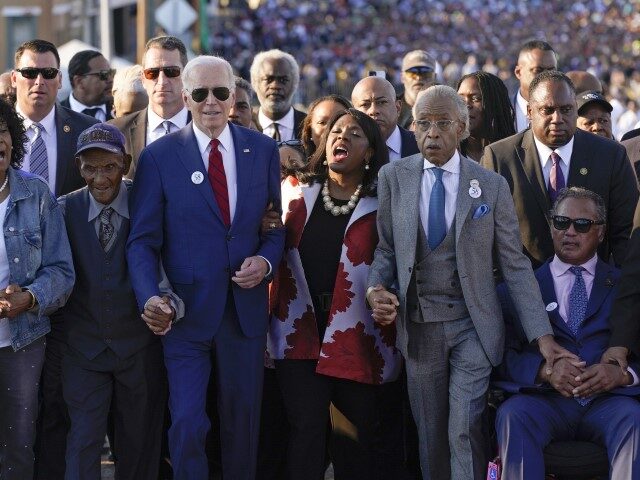 President Joe Biden begins to walk across the Edmund Pettus Bridge in Selma, Ala., Sunday, March 5, 2023, to commemorate the 58th anniversary of "Bloody Sunday," a landmark event of the civil rights movement. With Biden is Rep. Terri Sewell, D-Ala., the Rev. Al Sharpton, the Rev. Jesse Jackson and …