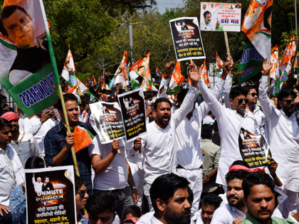 Supporters of opposition Congress party shout slogans as they protest against their leader