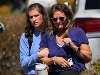 A family leave a reunification site in Nashville, Tenn., Monday, March 27, 2023 after several children were killed in a shooting at Covenant School in Nashville. The suspect is dead after a confrontation with police. (AP Photo/John Amis)