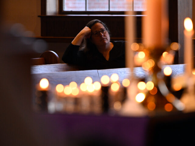 A person attends a prayer vigil at a Methodist church, Monday, March 27, 2023, in Franklin