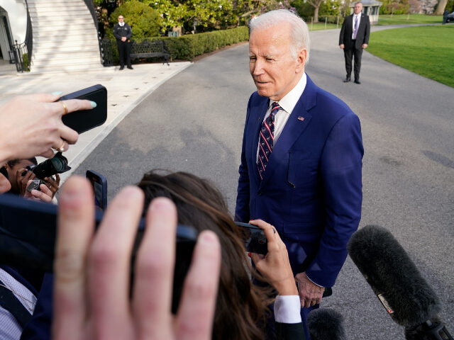 President Joe Biden talks with reporters after returning to the White House in Washington,