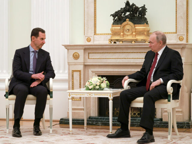 Russian President Vladimir Putin, right, listens to Syrian President Bashar Assad during t