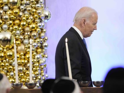 President Joe Biden walks past the White House menorah after speaking during a Hanukkah ho